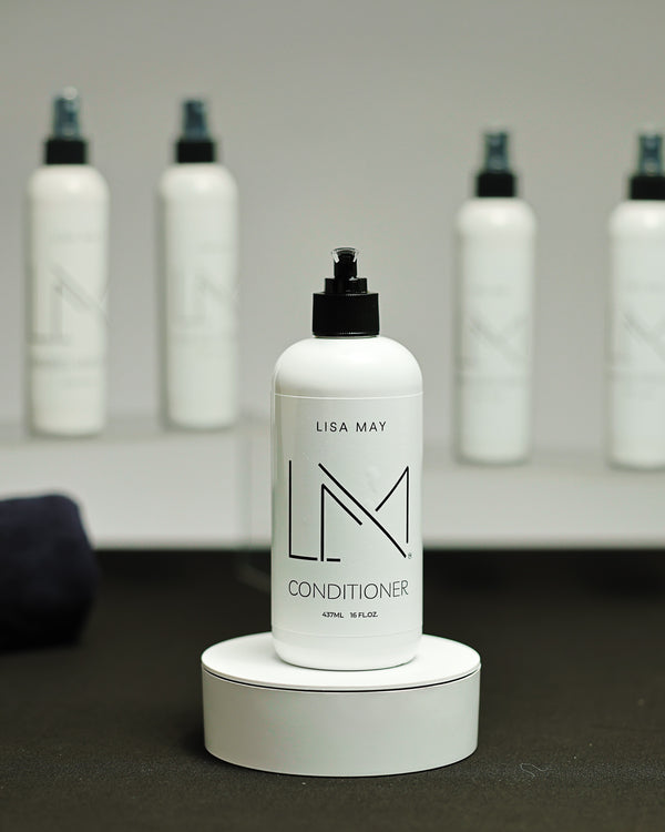 Lisa May Eco Hair Care Conditioner in a tall white pump bottle